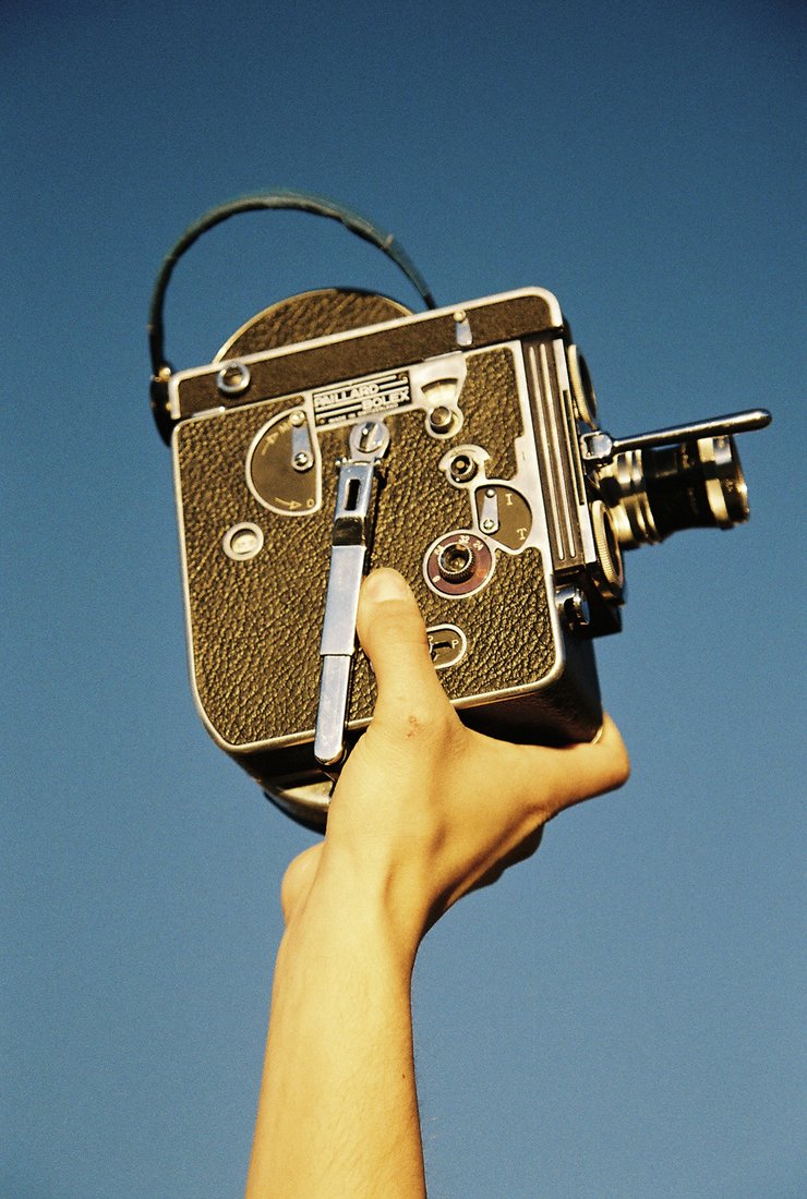 16mm Bolex camera held up against the sky